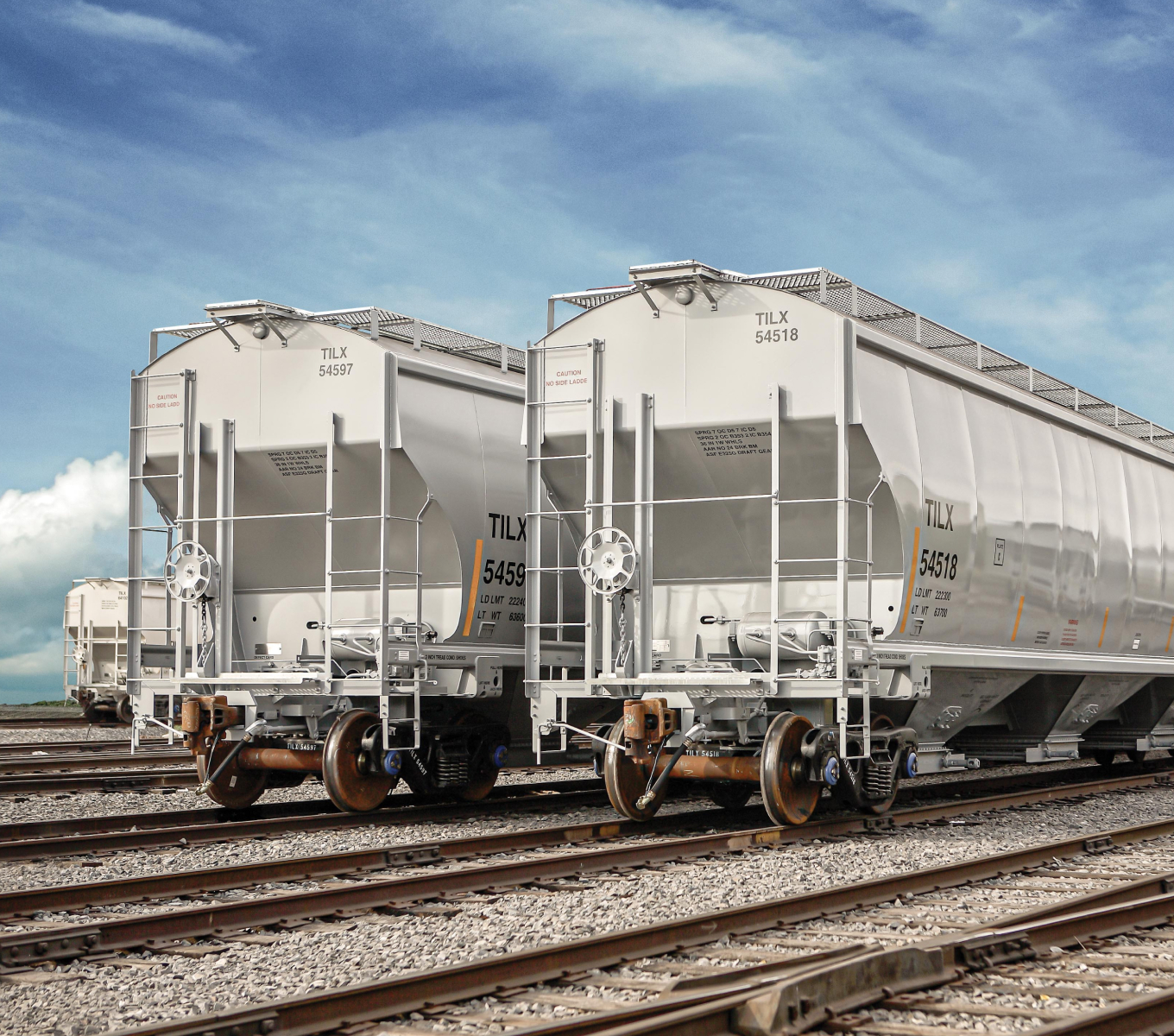 Two white covered hopper cars