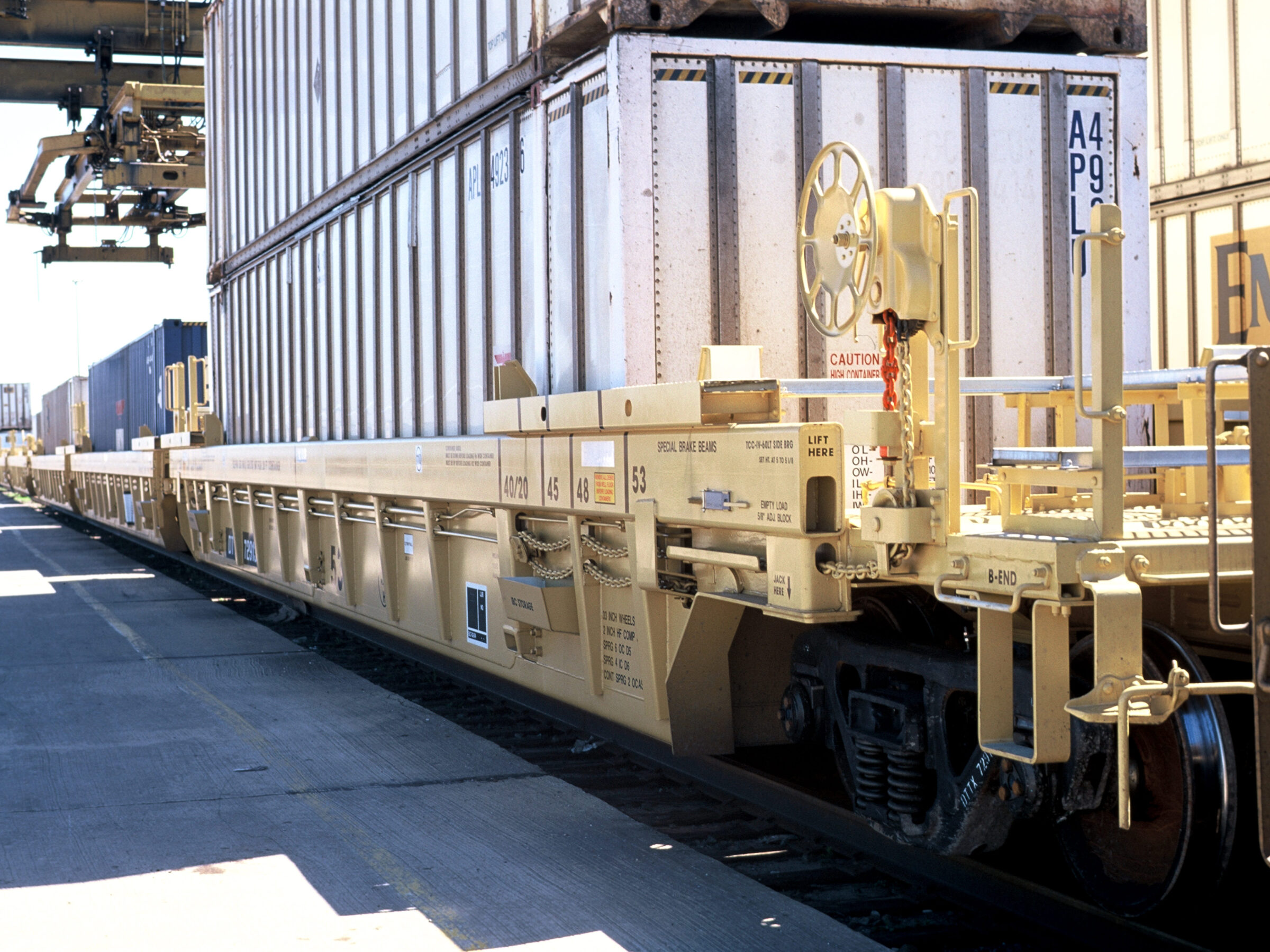 A yellow intermodal car